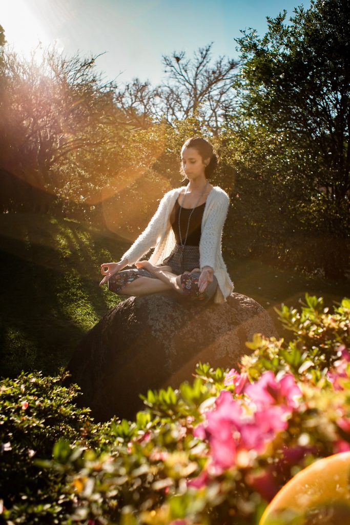 Woman meditating on a rock